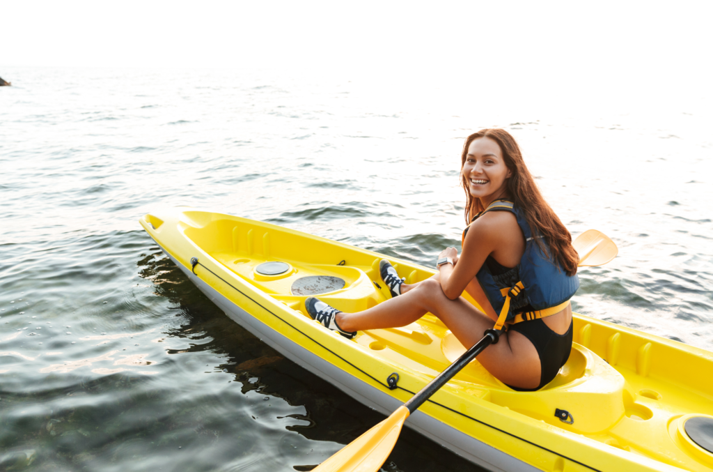 girl sitting in yellow paddle kayak